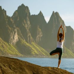 Woman,Is,Practicing,Yoga,Between,Mountains,In,Norway