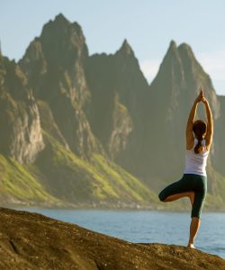 Woman,Is,Practicing,Yoga,Between,Mountains,In,Norway